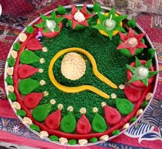 a cake decorated with green grass and red flowers