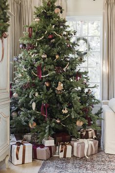 a christmas tree with presents under it