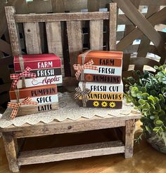 three farm fresh boxes sitting on top of a wooden bench next to a potted plant