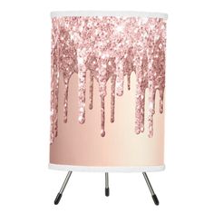 a pink and white table lamp with glitter on the bottom that looks like icing