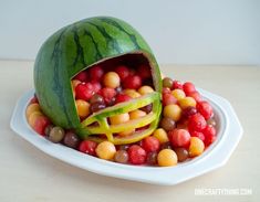 a watermelon shaped like a football helmet filled with fruit