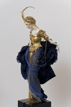 a statue of a woman in blue and gold