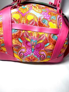 "Sierra zip top handbag is large and roomy! Approximately 13\" wide 10\" tall and 6\" deep. Because each bag is made by hand, approximate dimensions may vary slightly. Exterior features Tula Pink, Owl Print and magenta faux leather accents. Front features a slip pocket for quick access. Rainbow nylon zipper closure on top. Base features turquoise colored faux leather and purse feet. Interior is fully lined with turquoise cotton and features a zippered pocket and slip pocket. Pattern by Swoon patterns \"Sierra zip top handbag\" Handmade by me." Pink Tote Duffle Bag With Removable Pouch, Pink Tote Bag For Trips, Pink Tote Satchel With Zipper Pocket, Pink Tote Weekender Bag With Zipper, Pink Tote Weekender Bag With Zipper Closure, Pink Bag With Zipper Closure For Trip, Pink Shoulder Weekender Bag, Pink Satchel Weekender Bag, Pink Satchel Duffle Bag