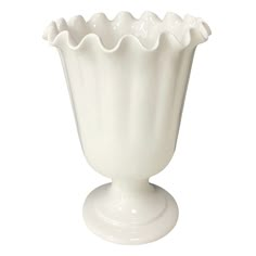 a white vase sitting on top of a table