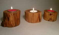 three wooden candles sitting on top of each other