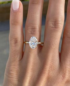 a woman's hand with a ring on it and a diamond in the middle