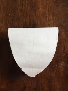 a piece of white paper sitting on top of a wooden table