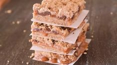 there are four bars stacked on top of each other with peanut butter and chocolate toppings