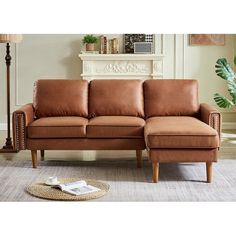 a brown leather couch sitting on top of a rug