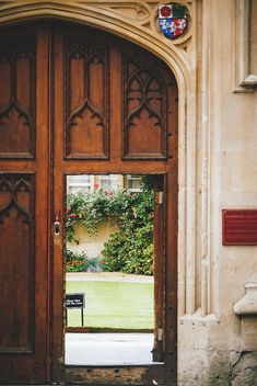 an open wooden door with a bench in front of it