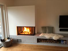 a living room with a fire in the fireplace