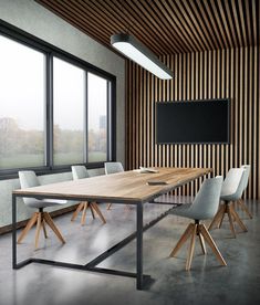 an empty conference room with chairs and a wooden table in front of a large window