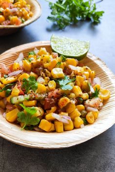 mexican corn salad with cilantro and lime on the side