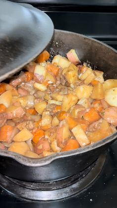 a pan filled with food sitting on top of a stove