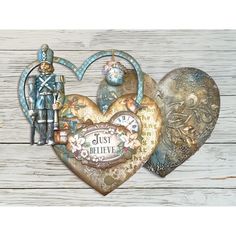 two heart shaped paper pieces with an image of a soldier on one and a clock on the other