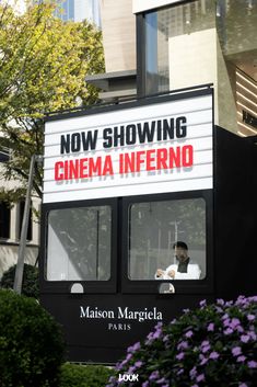 there is a sign that says now showing cinema inferno on the side of a bus