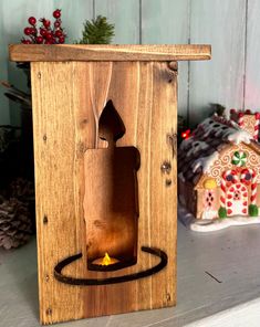 a wooden box with a lit candle in it