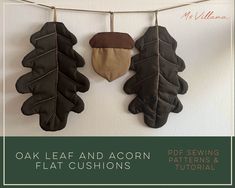 three leaf and acorn shaped cushions hanging on a line with text overlay that reads oak leaf and acorn flat cushions