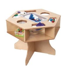 a wooden toy table with toys in it