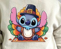 a person wearing a sweatshirt with an image of a cartoon character in a pilgrim hat