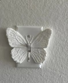 a white butterfly shaped light switch cover