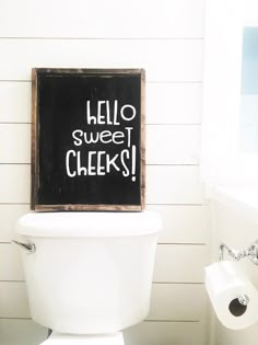 a toilet with a chalkboard that says hello sweet cheeks