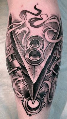 a black and white tattoo on the leg of a man with scissors, wrench and pipe