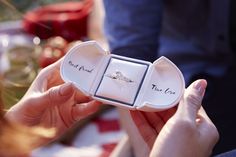 a woman holding an engagement ring in a box with the words true love written on it