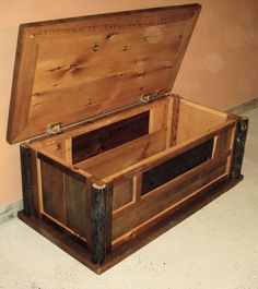 an open wooden box sitting on the floor next to a wall and carpeted floor