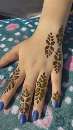 a woman's hand with henna tattoos on it