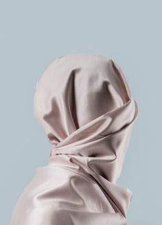 the back of a woman's head covered in a satin fabric