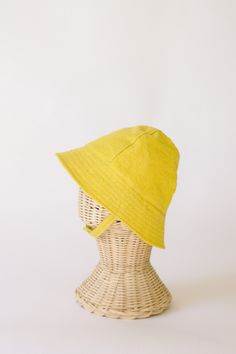 "This yellow baby and toddler summer sun hat is the perfect thing for sunny days!  Washable linen makes it an easy go to for at the park, the beach, or even the backyard!  This hat will protect delicate baby skin from the sun and will quickly become a favorite accessory! I made this sun hat from a bright yellow linen for a fun day in the sun.  The strap closes with snaps under the chin keeps them from pulling it off.  Brim measures approx. 2.25 inches. SIZES AVAILABLE 0-3 mos. - fits 14\" to 16\ Playful Adjustable Summer Hat, Playful Summer Hats With Adjustable Fit, Adjustable Cotton Summer Hat, Adjustable Cotton Bucket Hat For Summer, Summer Lightweight Adjustable Bucket Hat, Summer Sun Hat In Solid Color For Everyday, Adjustable Summer Cotton Bucket Hat, Summer Cotton Bucket Hat With Adjustable Fit, Adjustable Cotton Sun Hat For Summer