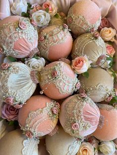 some pink and white ornaments are in a box with flowers on it's side