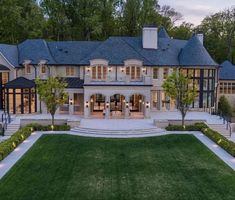 a large house with lots of windows and landscaping