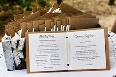 a table topped with lots of brown and white cards next to a paper bag filled with papers