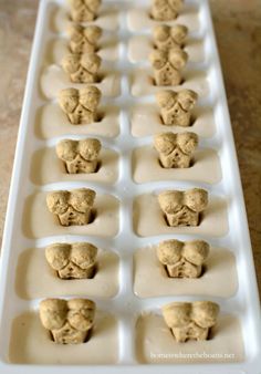 an ice tray filled with cookies in the shape of heads