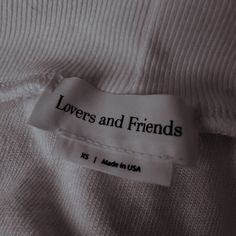 a label on a white shirt that says lovers and friends