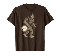 a brown t - shirt with an image of a bigfoot holding a baseball bat