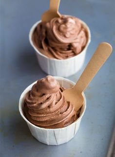 two white cups filled with chocolate ice cream