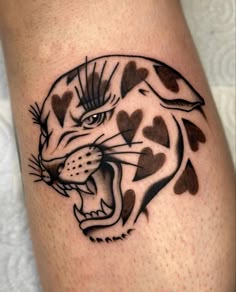 a black and white tiger with hearts on it's leg