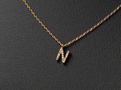 "Mini paved initial necklace makes a unique and personalized gift that sure to surprise and delight just about anyone on your list. 🤍This stylish pendant necklace features a mini monogram with bamboo textured initial is an ideal gift for moms, sisters, daughters, hostesses - and even yourself! - it's a way to reflect one's individuality with an added touch of charm.   🤍Size:  Chains- 16 \"with 2\" extension Pendant: 0.2\" height and 0.2\" wide. 🤍Our jewelry comes in gift boxes. You can add pe Everyday Jewelry: Initial Pendant With Name, 14k Gold Initial Pendant Necklace - Gift For Her, N Letter Pendant, N Necklace, N Pendant Letter Gold, Gold-tone Initial Pendant Jewelry With Gold Chain, Initial N, Monogram Pendant, Letter N