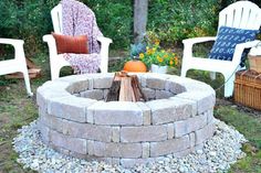 an outdoor fire pit with chairs around it