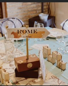 a table set up with wine glasses and place cards