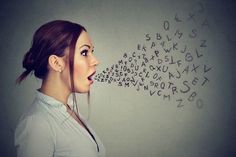 a woman with her mouth open and letters written on the wall above her head in front of her