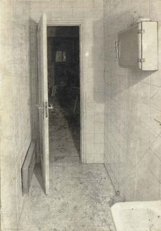 an old black and white photo of a bathroom