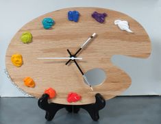 a wooden clock with different colored candies on it