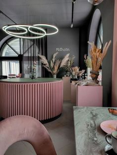 the interior of a pink and black restaurant