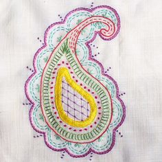 a close up of a piece of cloth with an embroidered design on the front and back