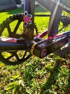 the rear end of a bicycle parked on grass