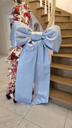 a large blue bow tied to the side of a stair case